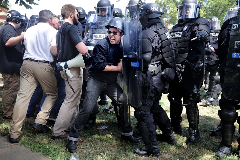 White supremacist demonstrators in Charlottesville push against riot police on August 12, 2017, with virtually no repercussions from police (Photo by Chip Somodevilla/Getty Images)
